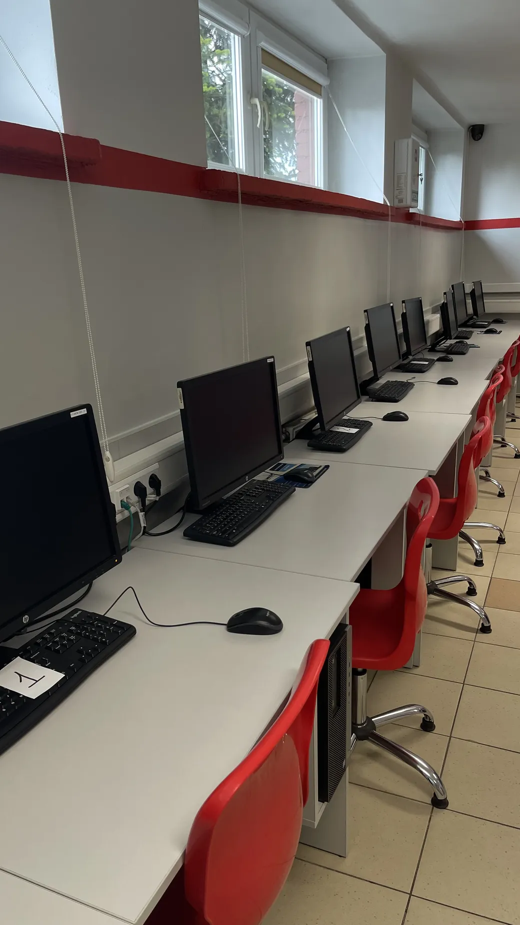 Pracownia komputerowa w Technikum AWANS ze stanowiskami w rzędzie
